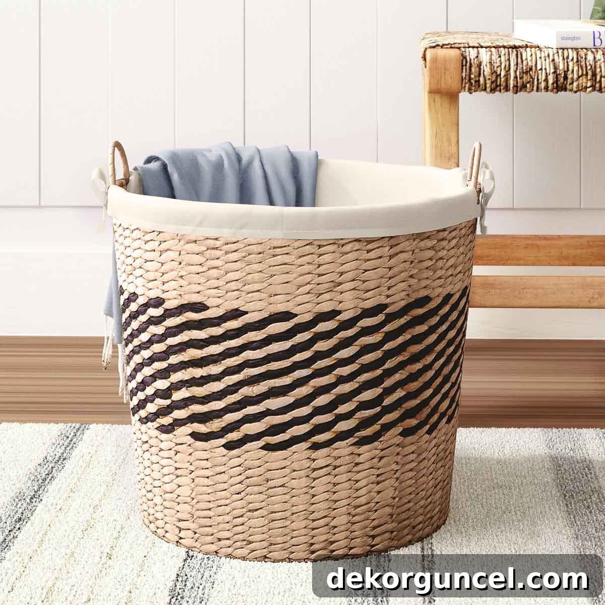 Woven basket with a black band used for practical and decorative shoe storage in a coastal bedroom setting