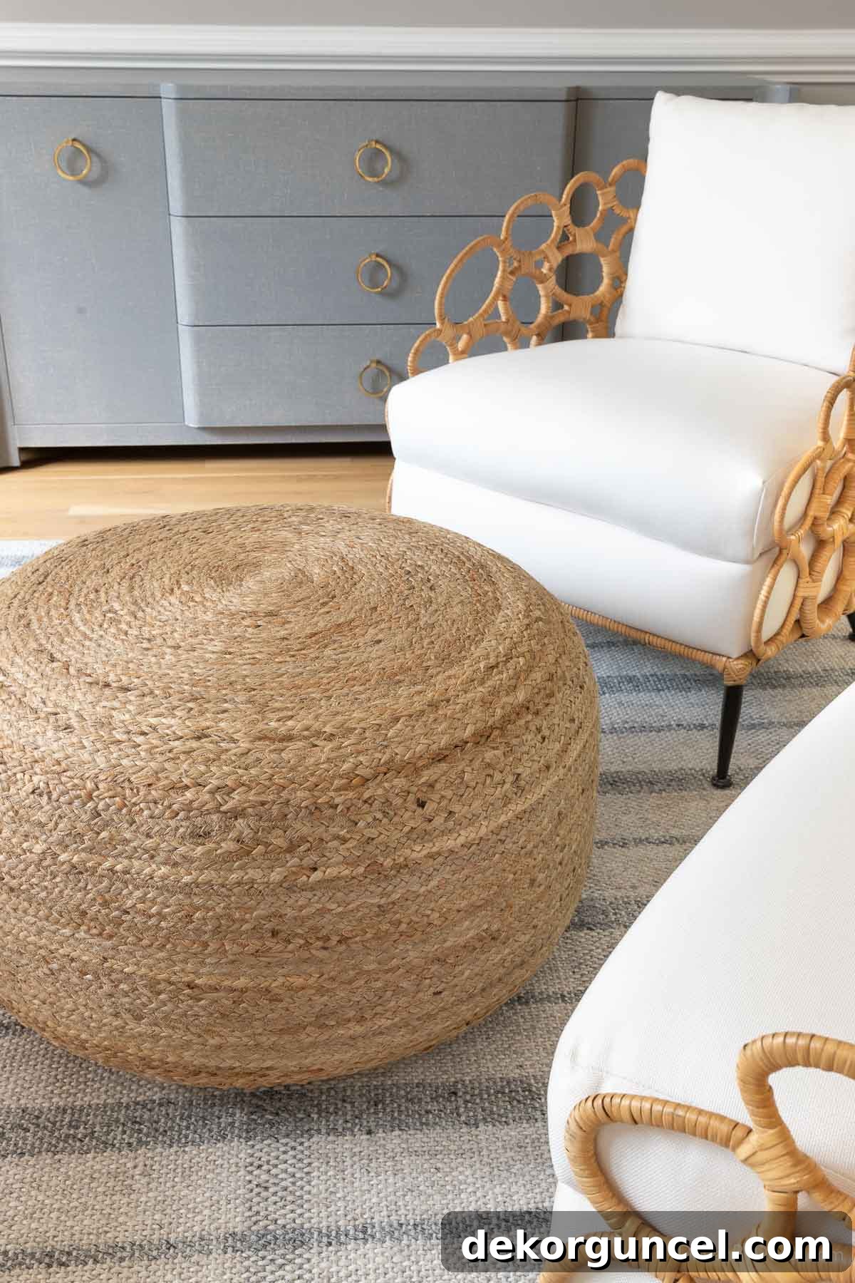 Jute pouf used as a shared ottoman between two accent chairs, creating a cozy and functional seating arrangement