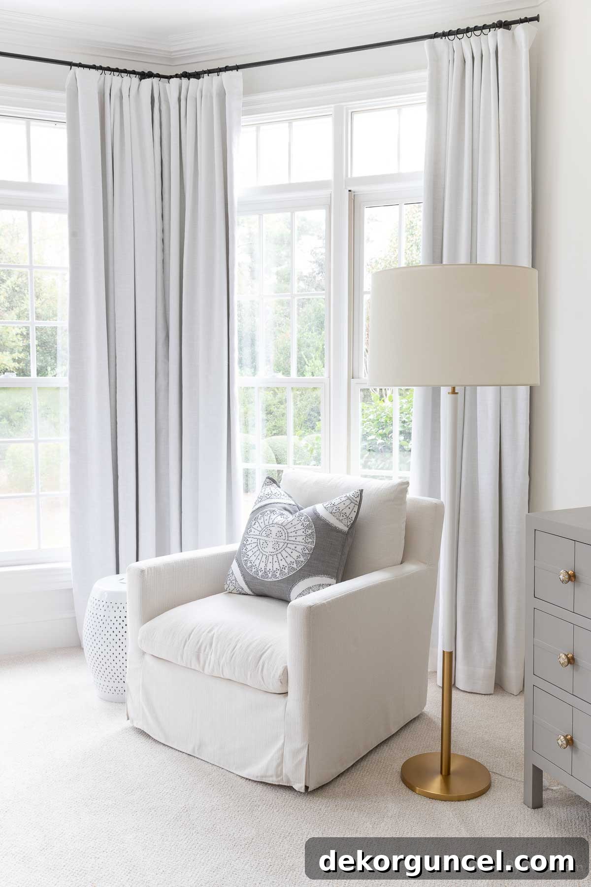Curtain rod height in a bedroom with chair and lamp