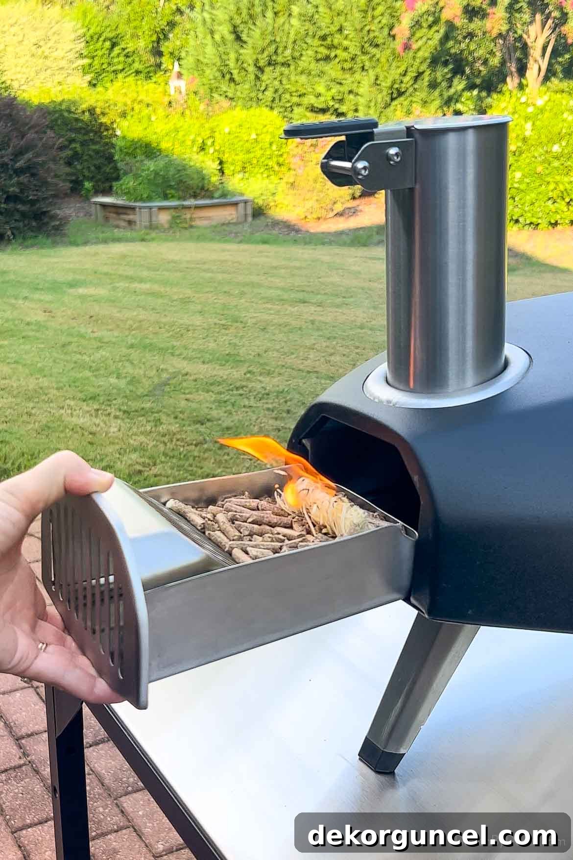 Score Big: Best Buy's Top 5 Labor Day Deals 3 Inserting lit wood pellets in Ooni pizza oven