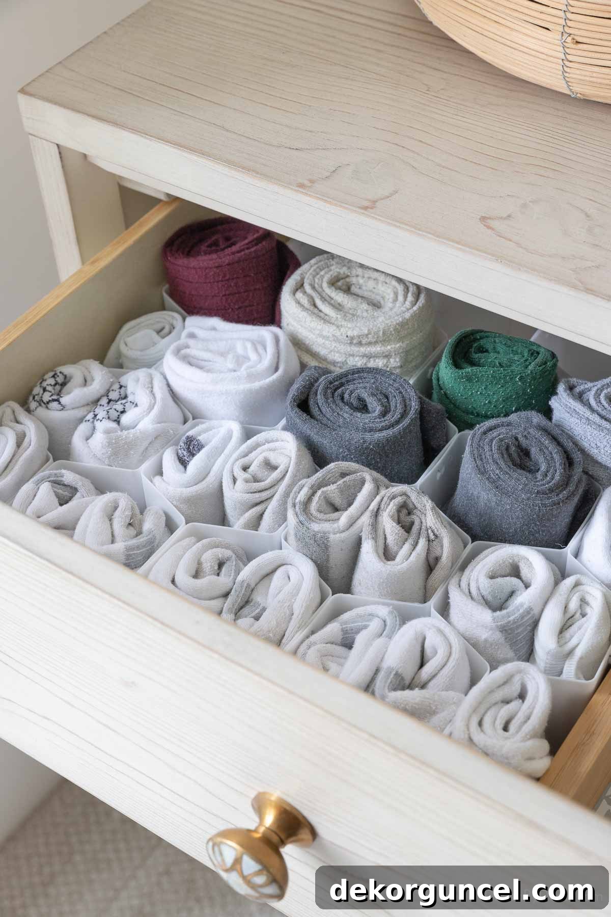 Socks neatly arranged in honeycomb drawer dividers