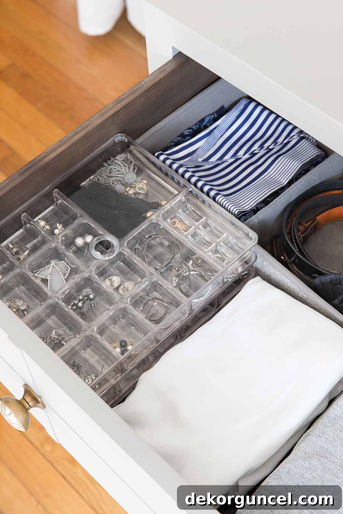 Stacked jewelry trays neatly arranged within a drawer for efficient storage