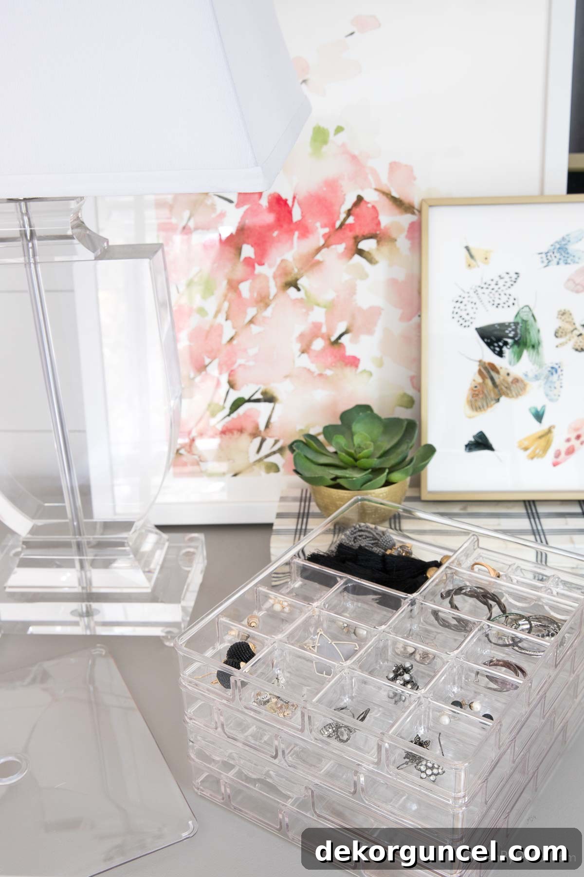 Multiple stacked jewelry trays showcasing organized necklaces, earrings, and rings