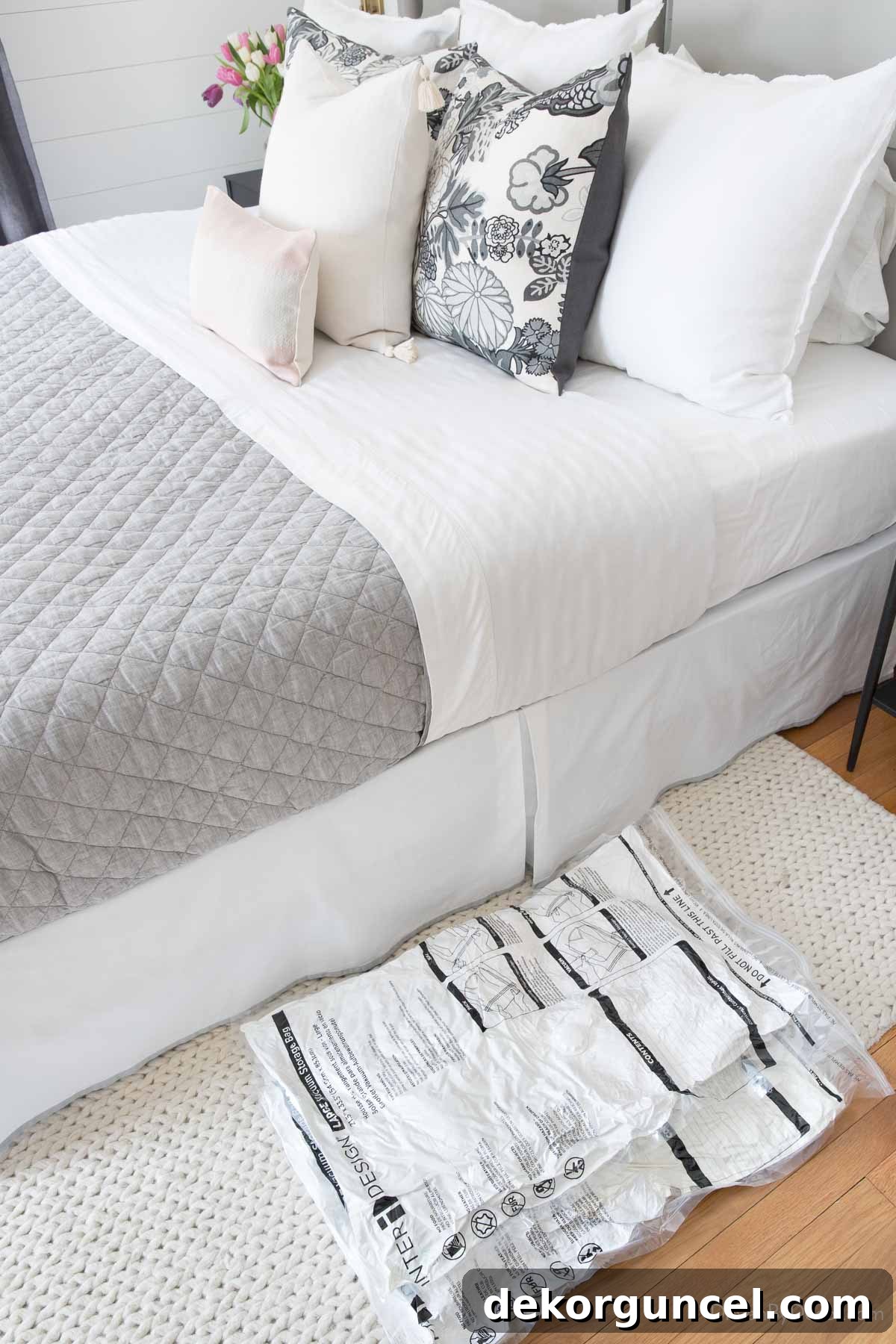 Vacuum storage bags neatly tucked under a bed as a clever bedroom organization solution