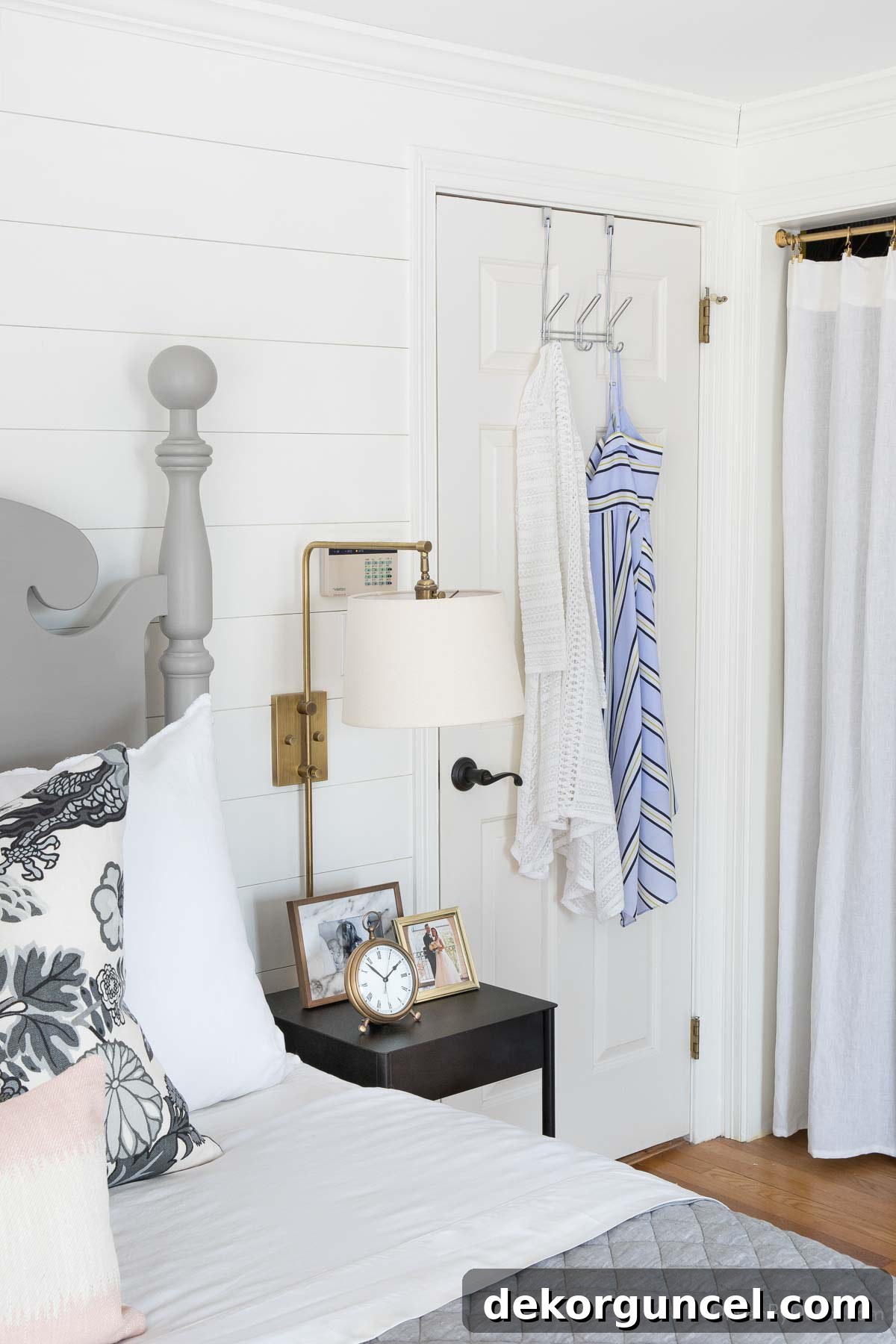 Over-the-door hanger with three hooks holding clothes for bedroom organization