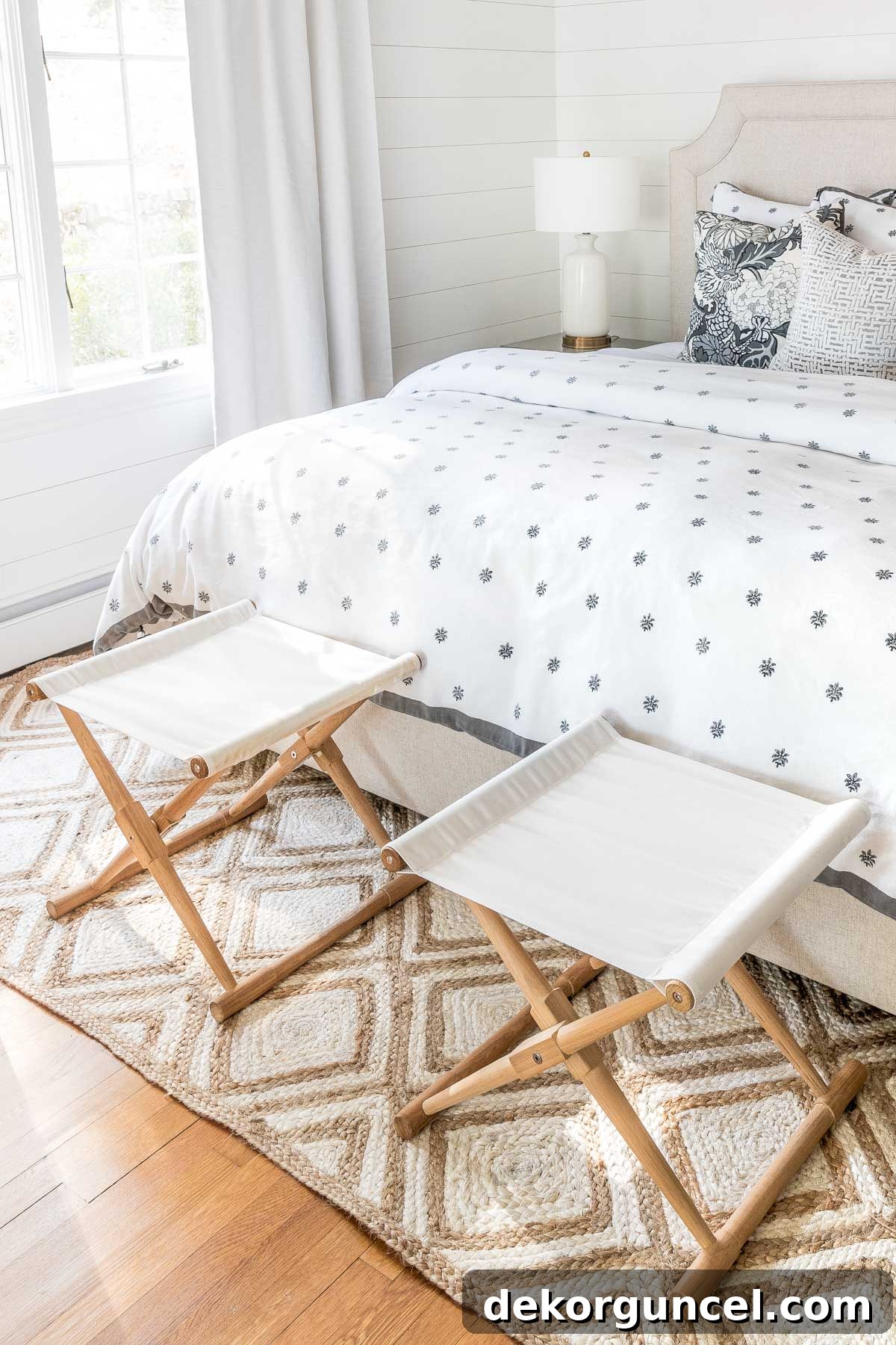 Pair of camp stools at the end of bed holding clothes for the next day, promoting bedroom organization