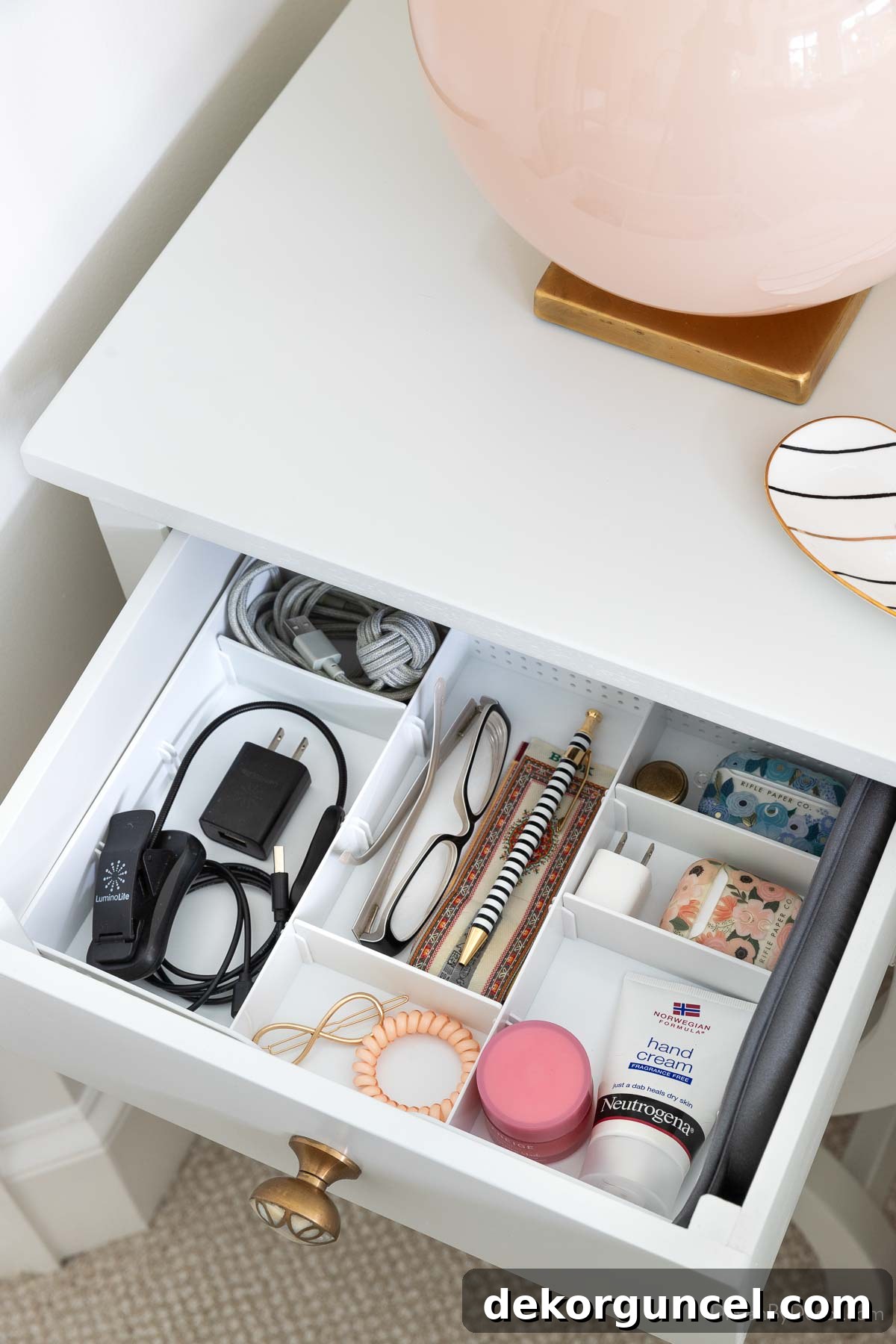 Shallow organizer tray neatly arranged within a bedroom nightstand drawer