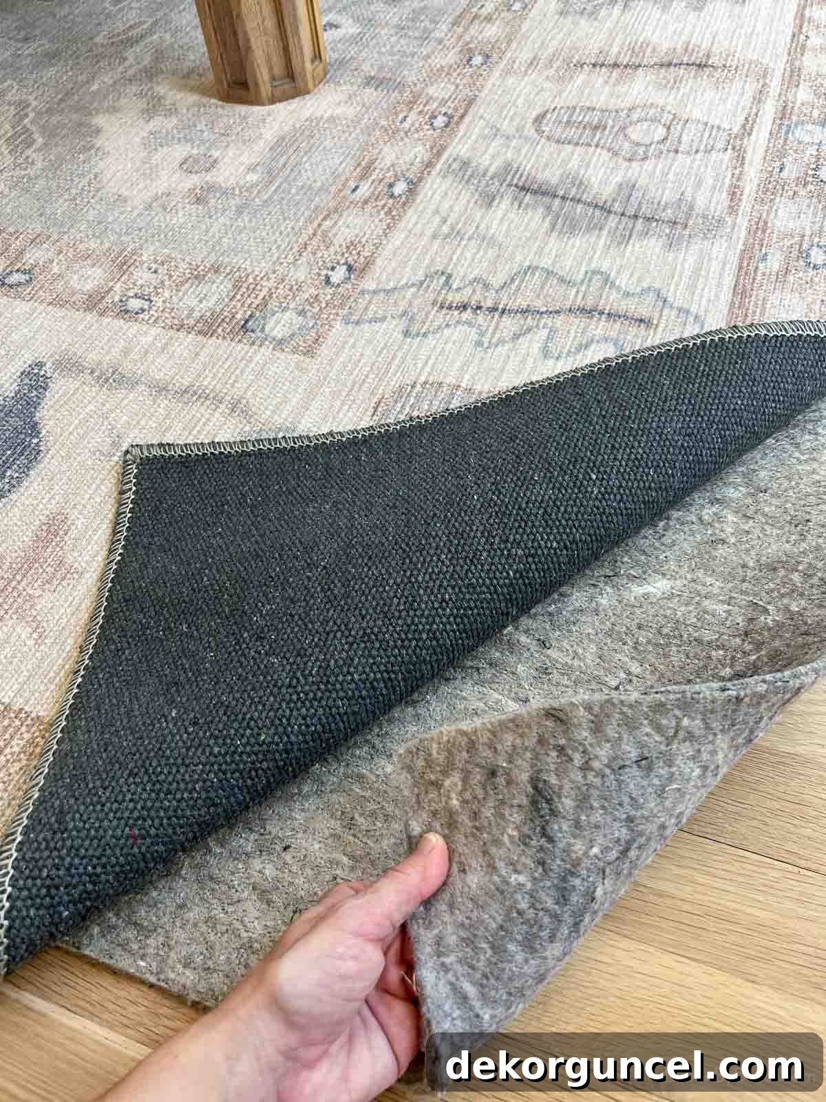 100% felt rug pad installed under a rug on hardwood floors, showcasing cushioning and protection