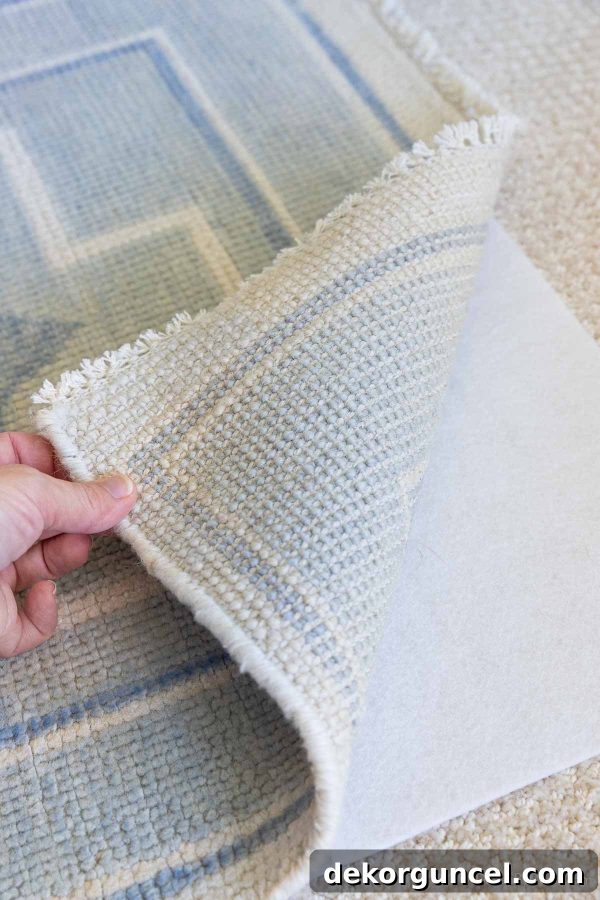 Rug placed on carpet with a specialized rug pad underneath, preventing shifting