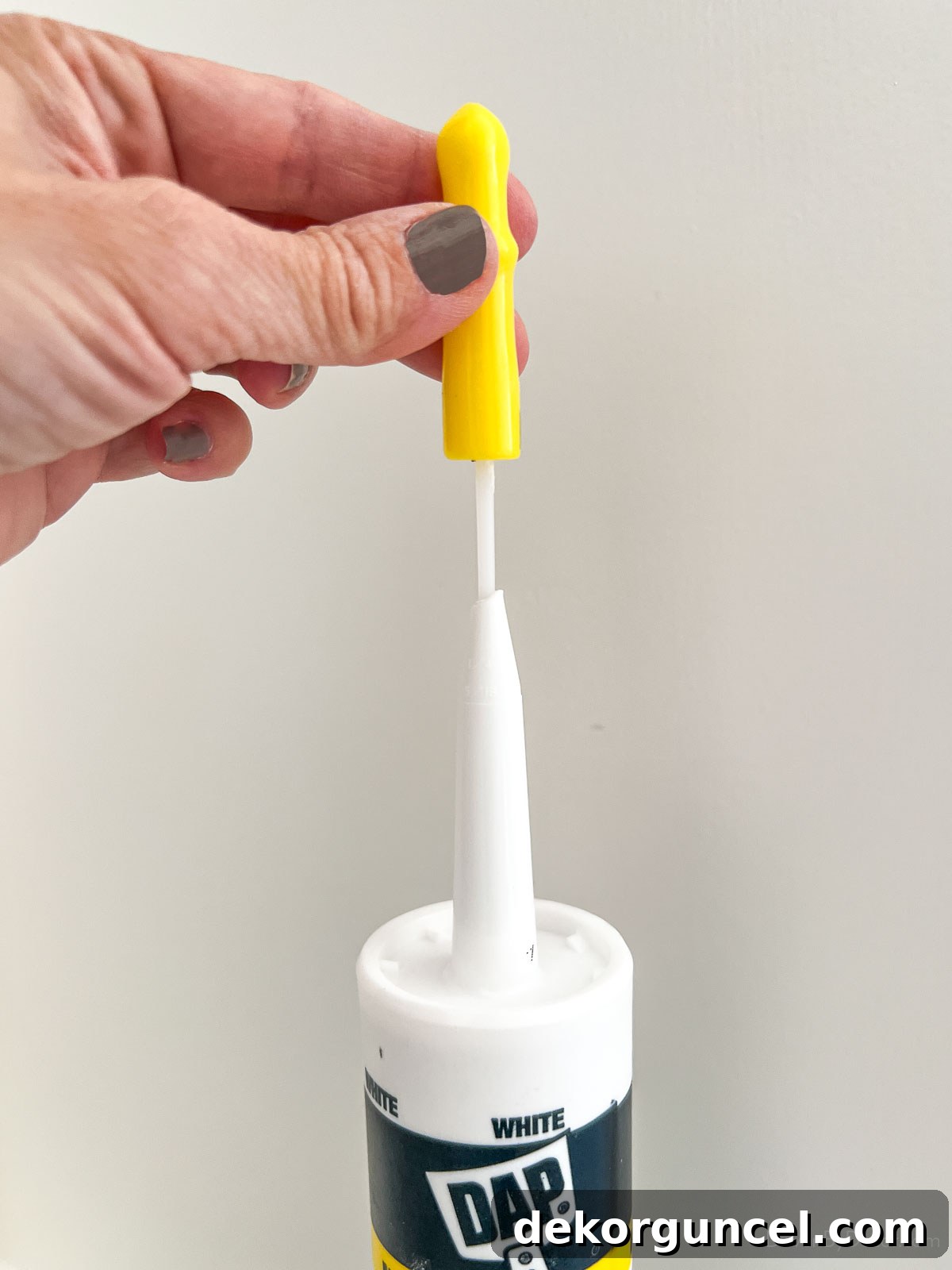 Piercing the internal seal on a caulk tube before use