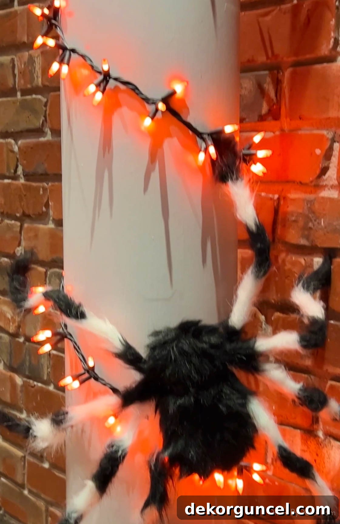 Simple, Spooky, and Fun Halloween Porch Decor Ideas 13 Hairy spiders and orange string lights on porch columns for Halloween