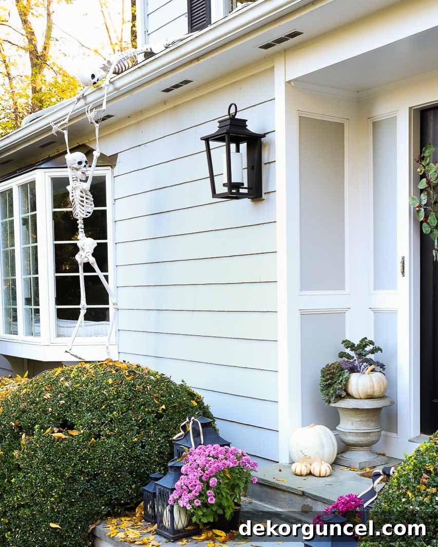 Simple, Spooky, and Fun Halloween Porch Decor Ideas 3 Skeletons climbing up house as Halloween porch decor