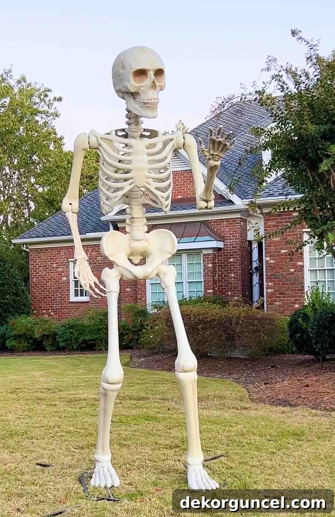 Simple, Spooky, and Fun Halloween Porch Decor Ideas 4 Giant skeleton in the front yard for Halloween
