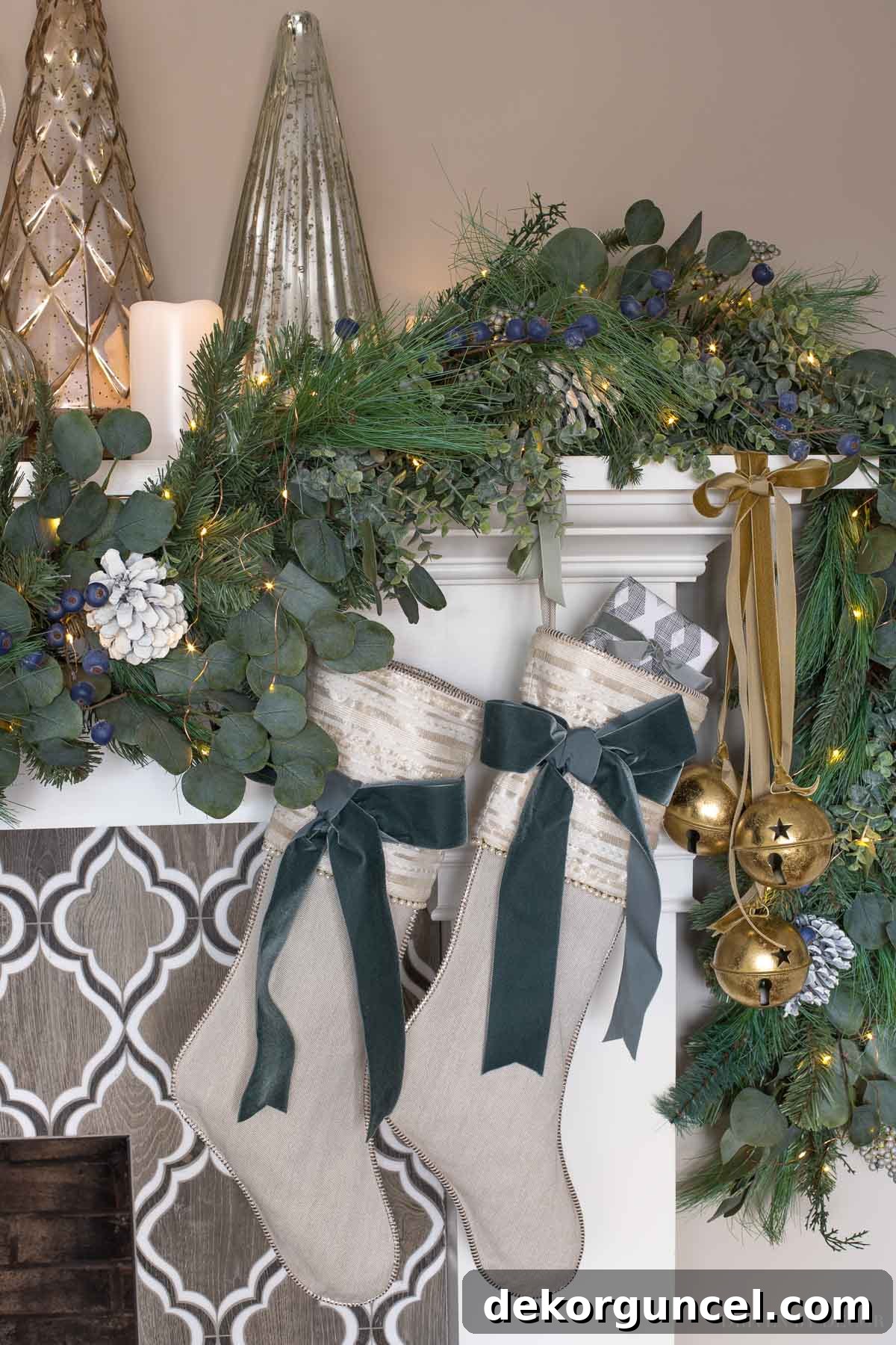 Large gold jingle bells tied with velvet ribbon on our fireplace mantel for Christmas