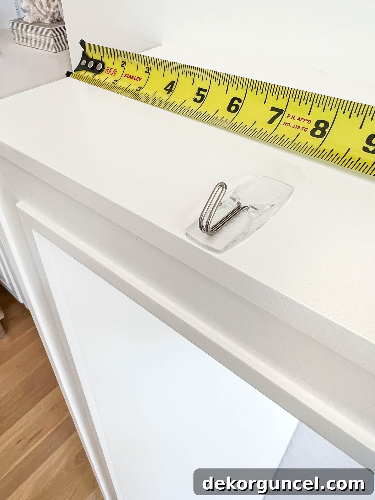 Command hook on top of fireplace mantel to hold garland