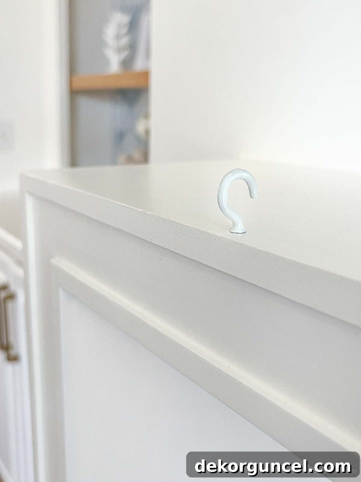 Cup hook screwed into wood fireplace mantel for hanging garland