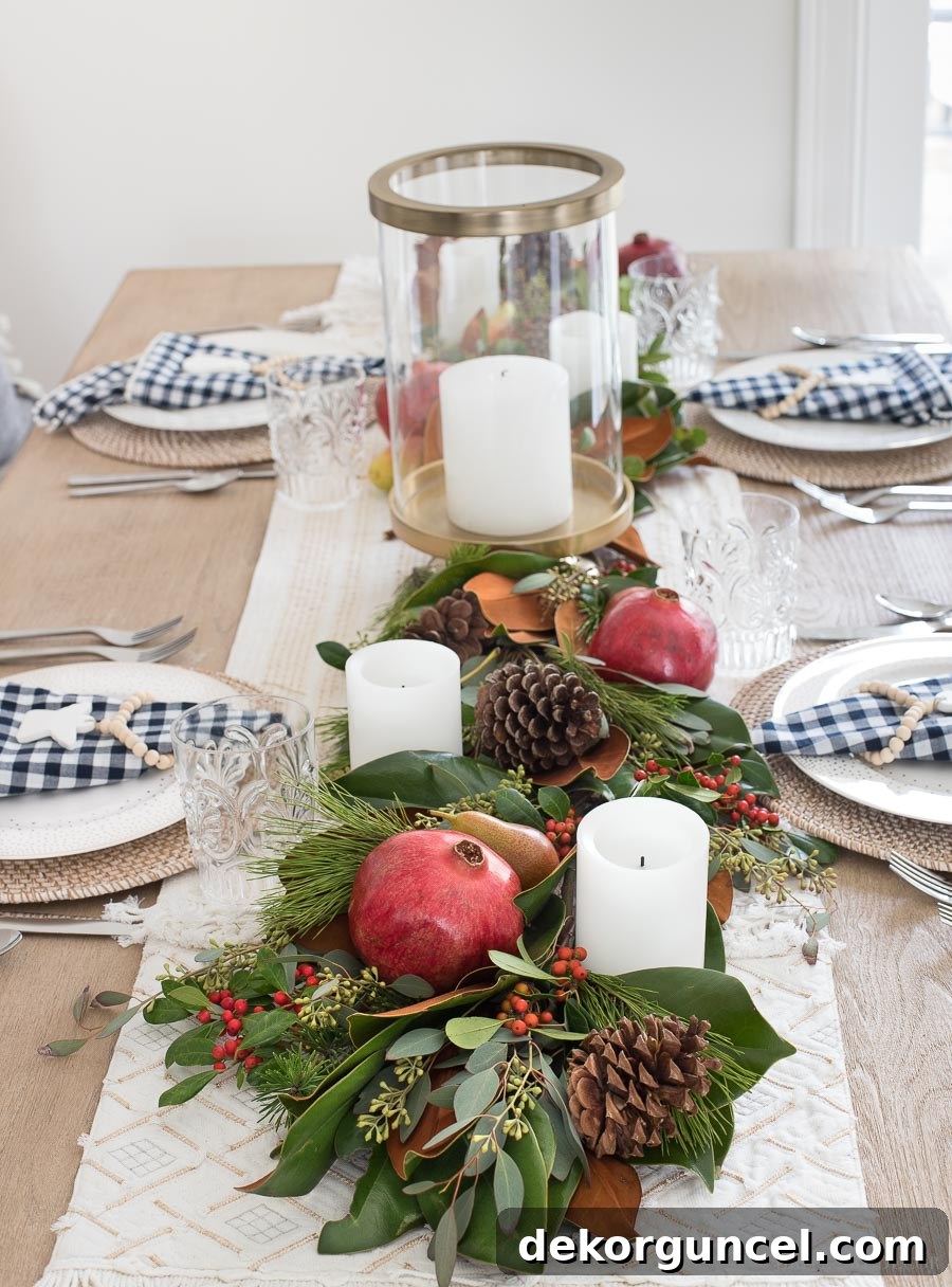 Gorgeous! This post gives you the step by step to making a live greenery table runner with magnolia leaves, greenery, fruit, and pinecones!