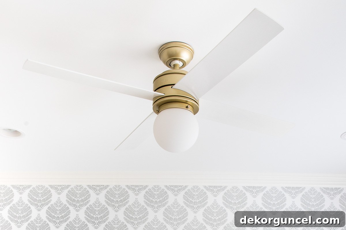 Favorite ceiling fan featuring a sleek brass base and pristine white blades, combining style and function
