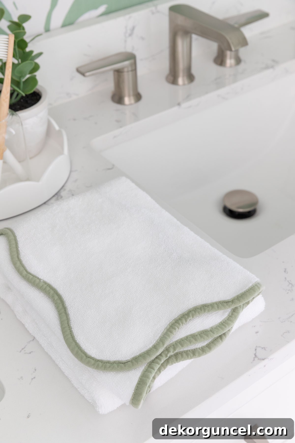 Neatly folded hand towel placed between two sinks on a double vanity, a temporary solution for towel placement