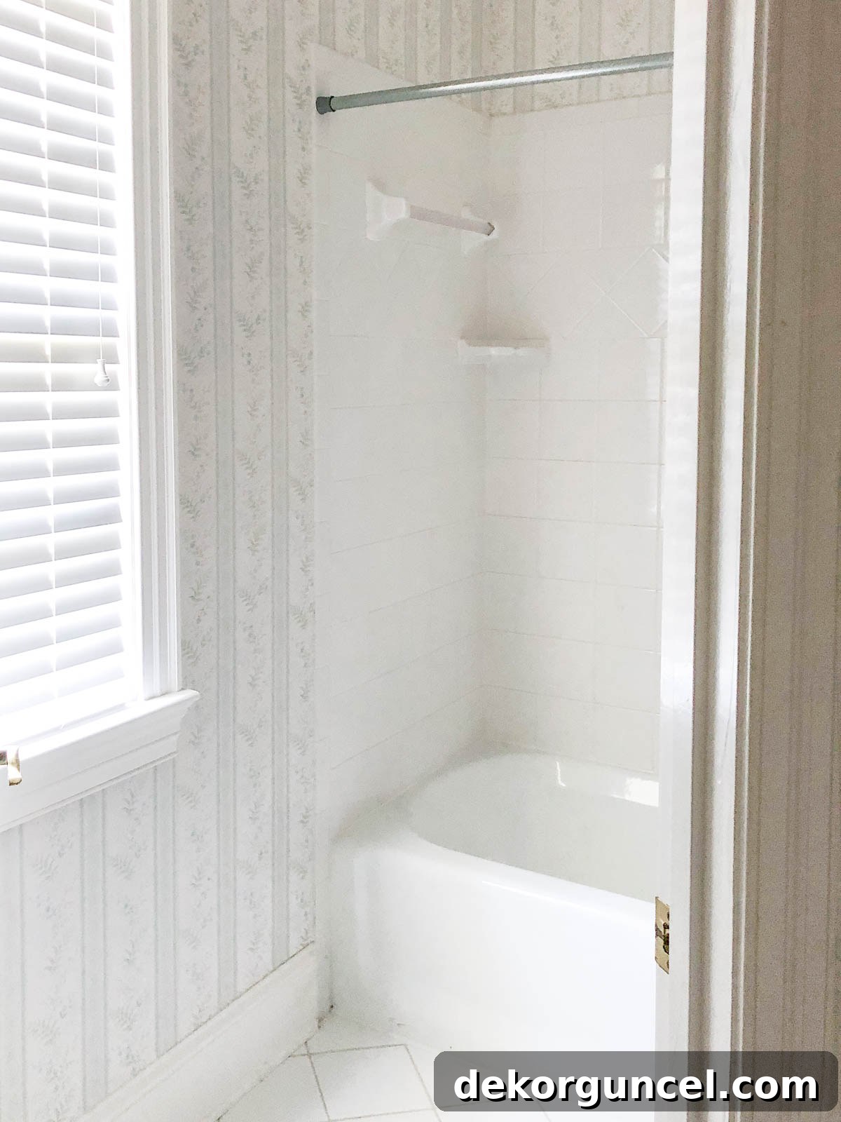 Our tub/shower combo before the renovation, showing an outdated and simple design with older fixtures