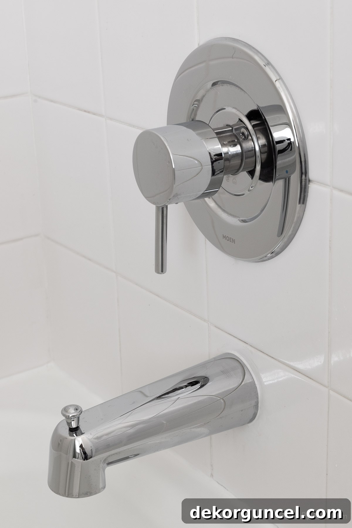 New chrome shower and tub hardware, featuring a modern valve trim kit and diverter spout for a sleek look