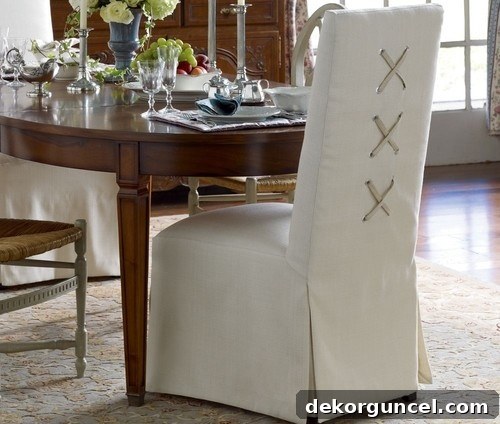 Slipcovered chairs with laced X back design