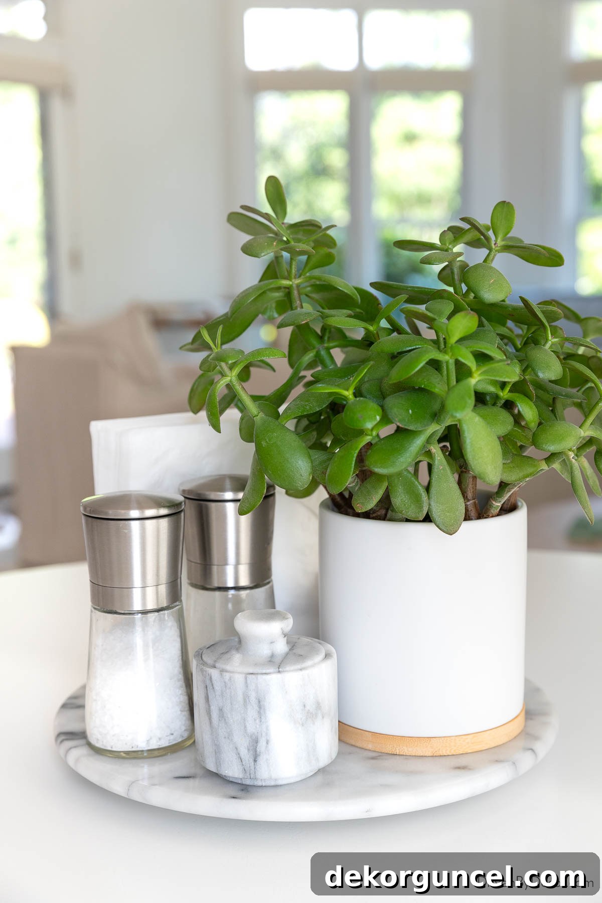 Everyday Dining Table Centerpiece Ideas 37 Marble lazy Susan with plant, napkins, and salt and pepper in the center of a kitchen table