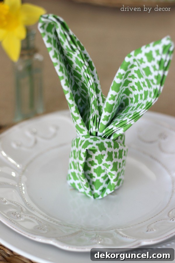 Napkin folded into rabbit ears - so cute for an Easter table setting!