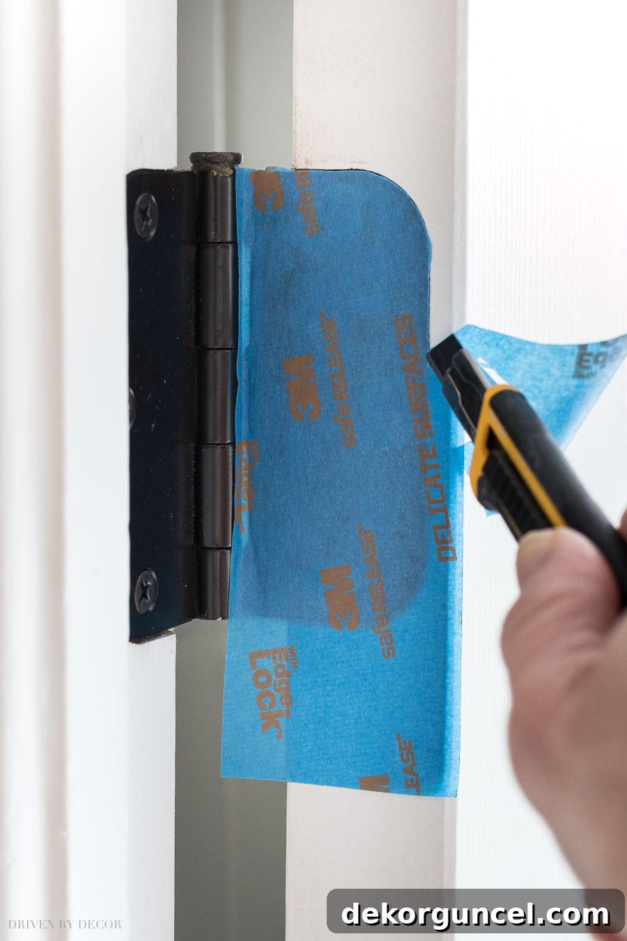To prep your door for painting, cover hinges with painter's tape and use a razor cut away extra tape by tracing around them!