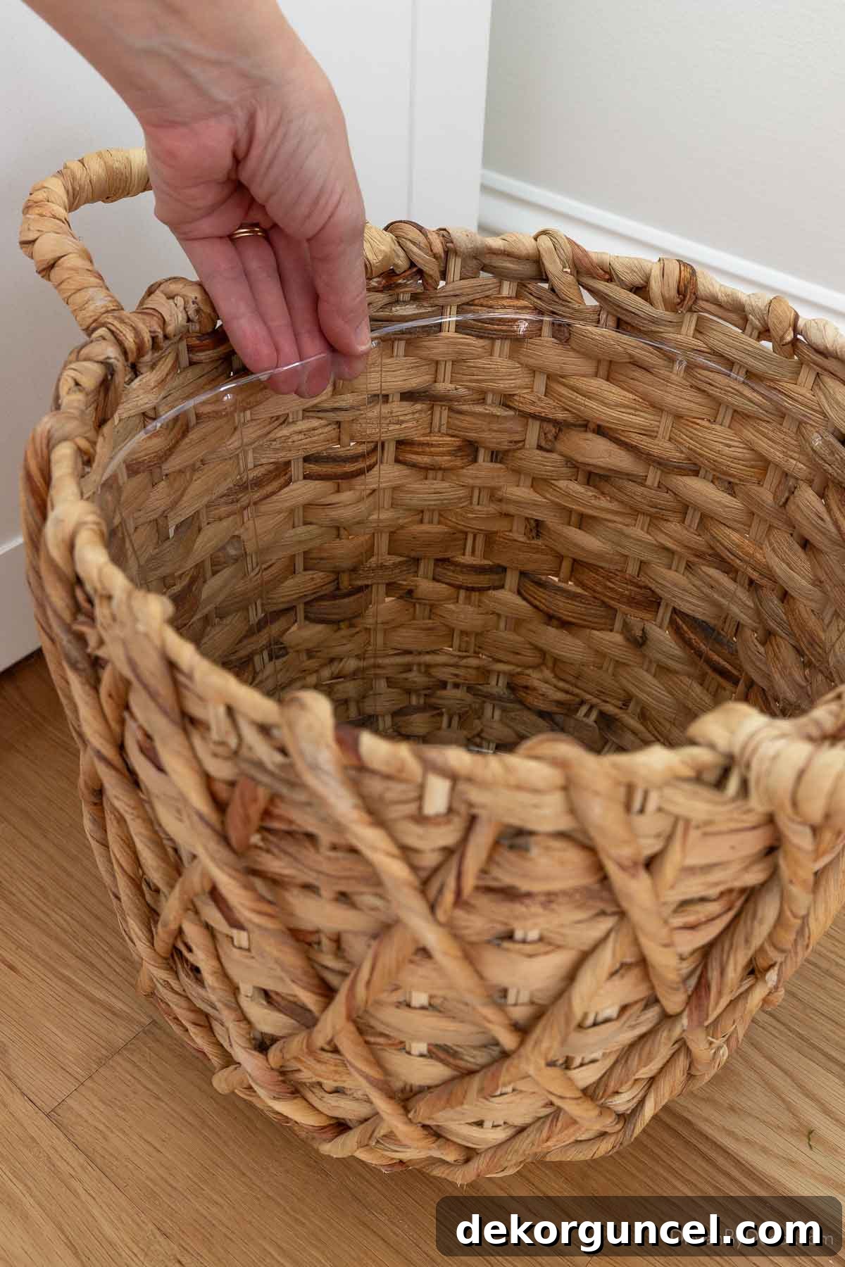 10 Smart Buys for Affordable Home Style 11 A close-up view of the clear plastic liner inside a woven planter, highlighting its practical design.