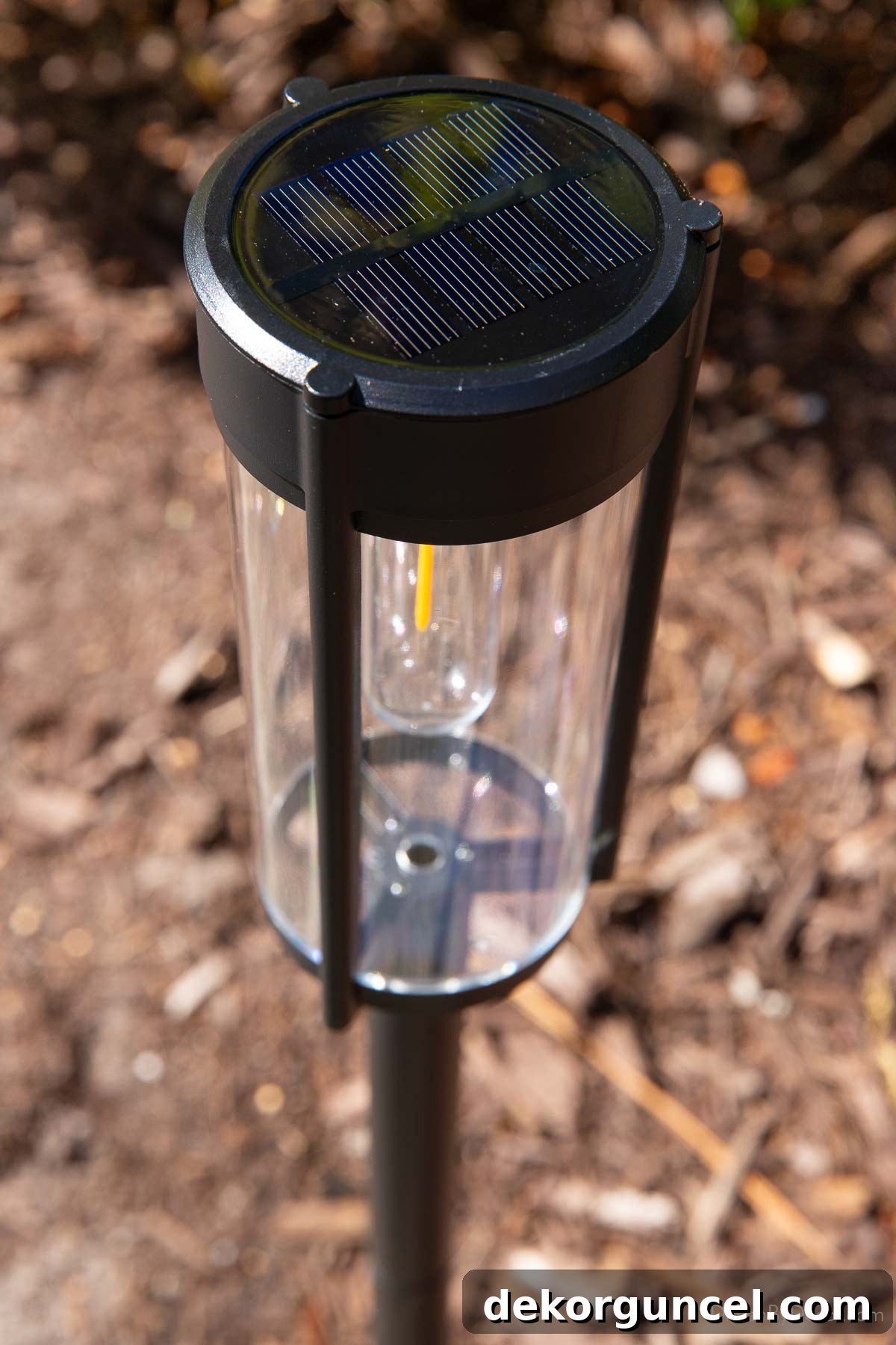 10 Smart Buys for Affordable Home Style 15 A close-up of the integrated solar panel on top of a solar-powered walkway light, highlighting its renewable energy source.