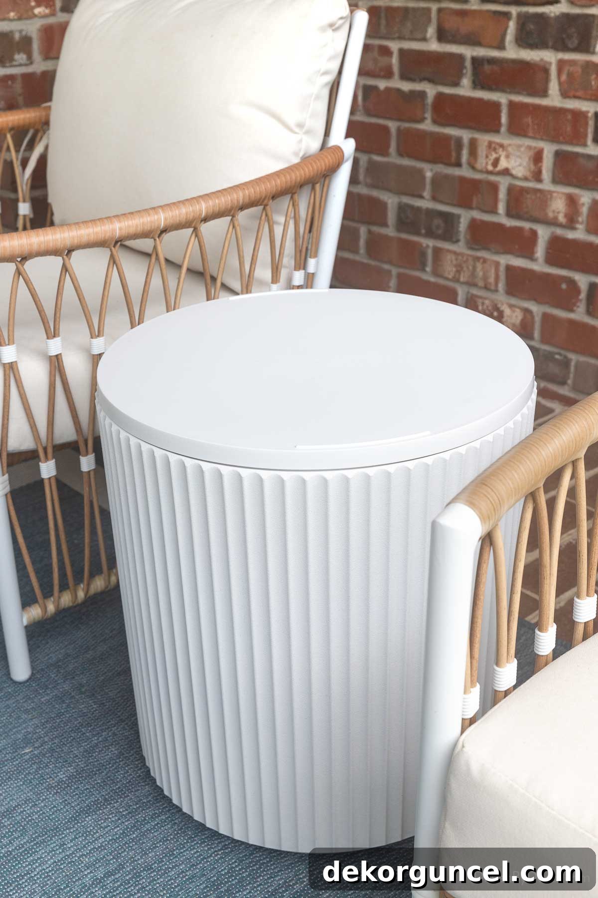 10 Smart Buys for Affordable Home Style 21 A modern fluted outdoor side table positioned between two chairs, ready for outdoor living.
