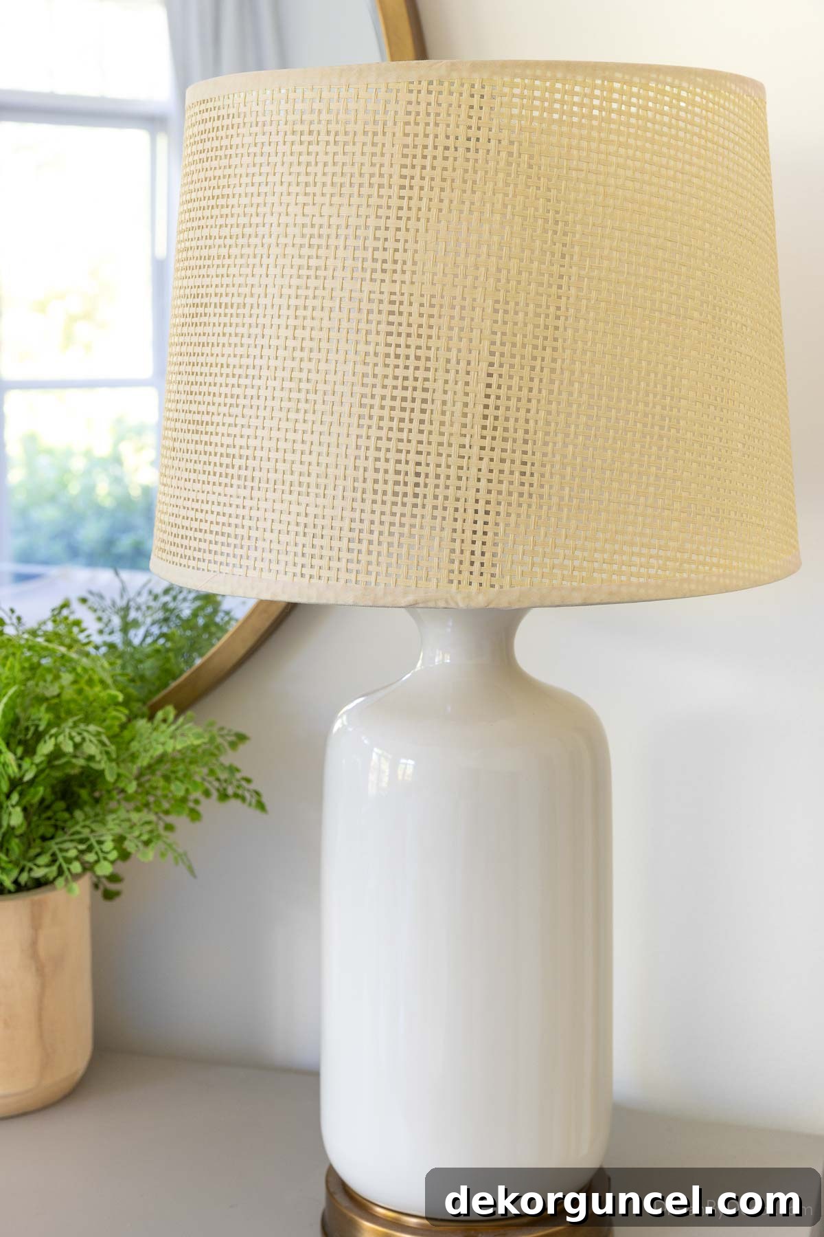 10 Smart Buys for Affordable Home Style 5 A stylish and affordable woven lamp shade resting on a crisp white lamp base, adding texture to the room.
