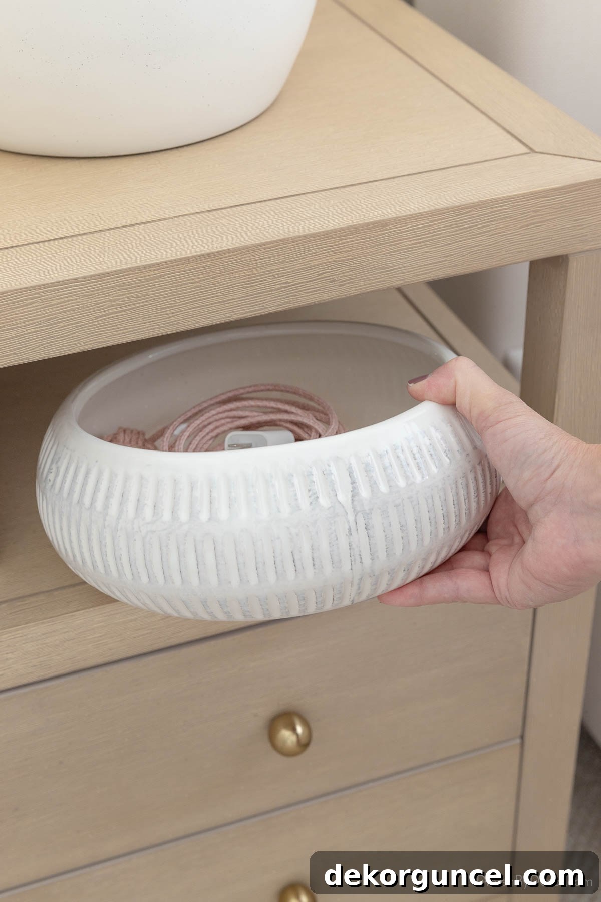 Curate Your Cozy Corner 10 Stylish Bedroom Updates 20 Shallow white planter used as bowl to hold charging cable on nightstand