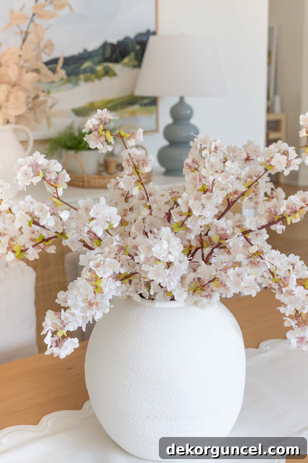 Faux cherry blossoms arranged as a stunning dining room centerpiece