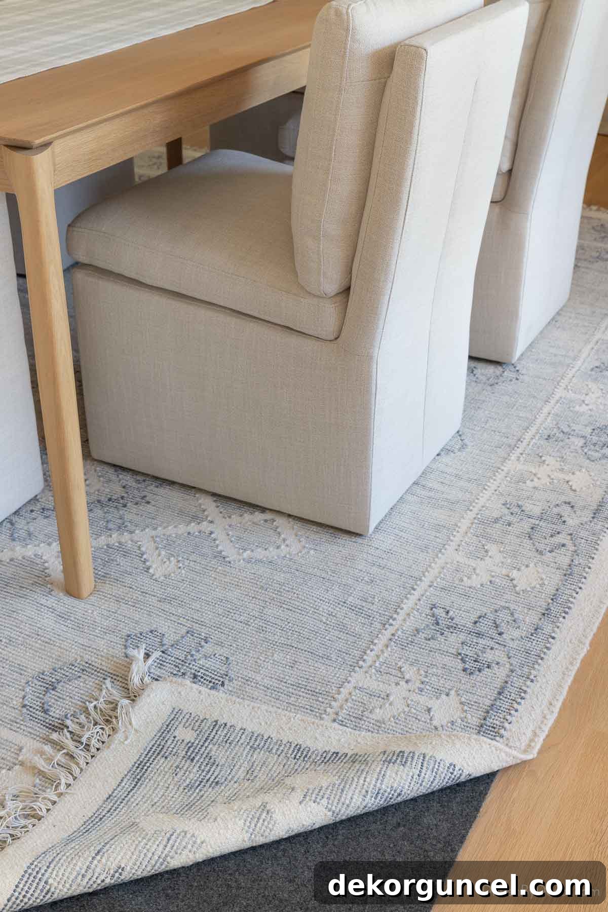 Rug pad visible beneath dining room area rug