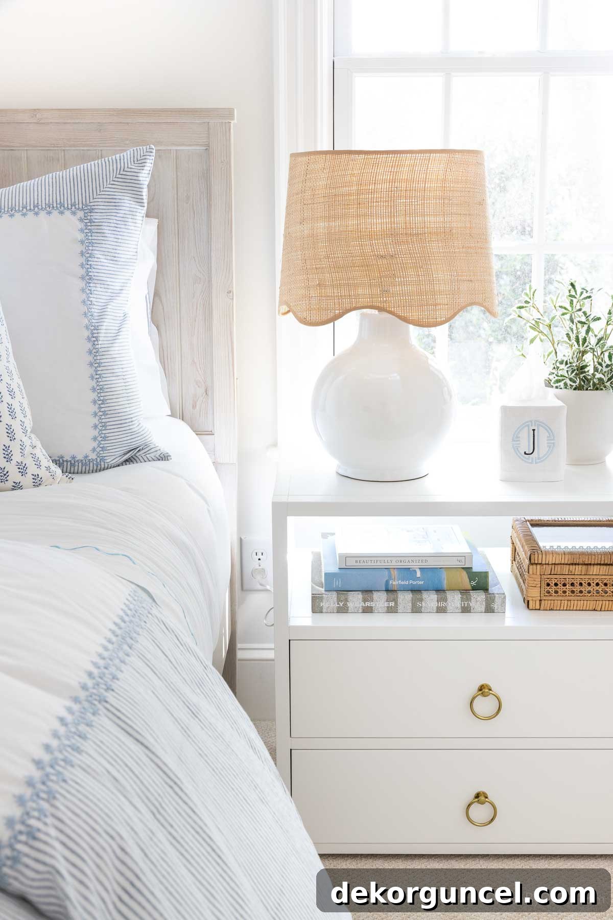 Round white lamp with scalloped rattan shade on bedroom nightstand