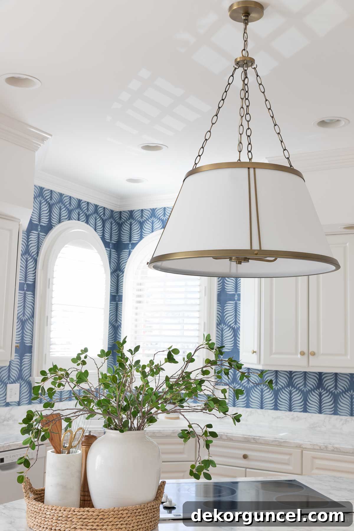 A large round pendant with a linen shade and brass accents previously used as kitchen island lighting in the pre-renovated kitchen.