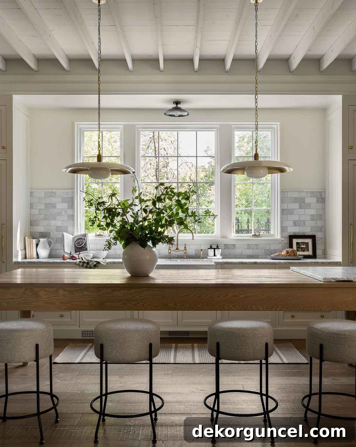 Two elegant saucer pendants with an opal finish creating soft pendant lighting over a kitchen island.