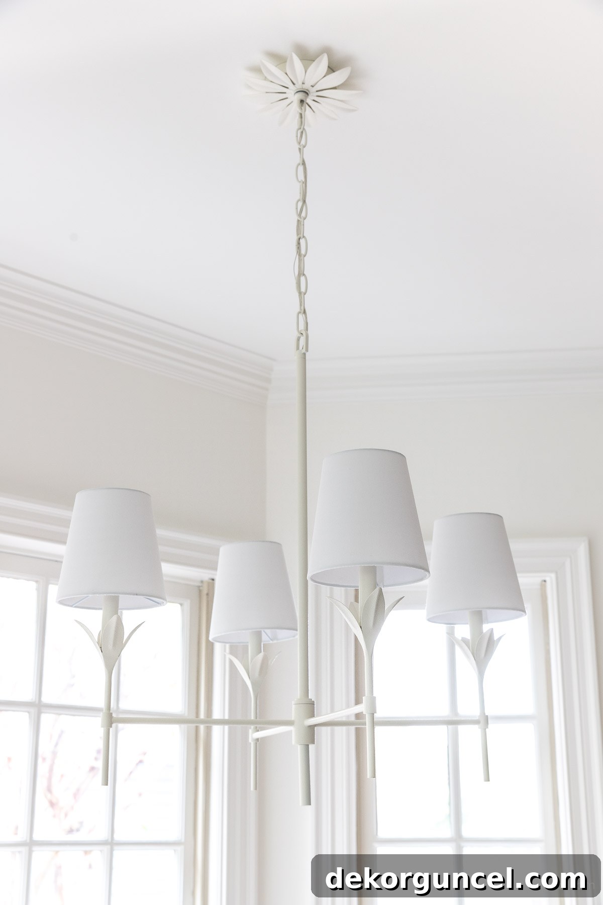 Modern matte white chandelier elegantly positioned over a kitchen dining table
