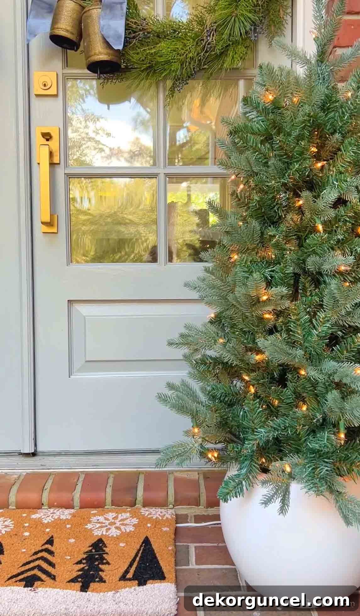Charming lighted mini Christmas tree in a white round pot on a festive front porch