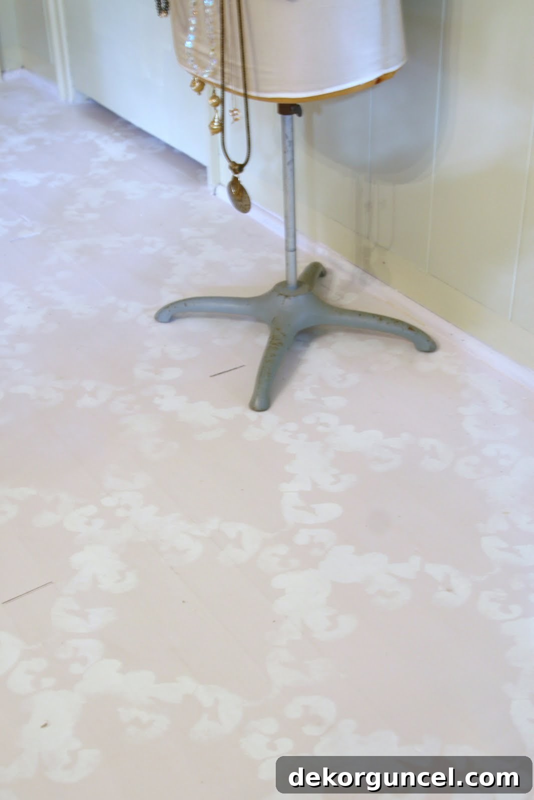 Charming chalk paint floors by Lady Butterbug, featuring a soft pink base with intricate Pure White stenciling, sealed with Annie Sloan Lacquer.