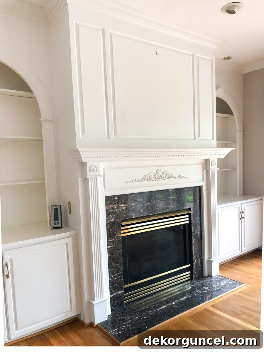 Spray Paint Your Brass Fireplace for an Instant Update 12 Our fireplace before being painted, showing the original brass and dated elements.