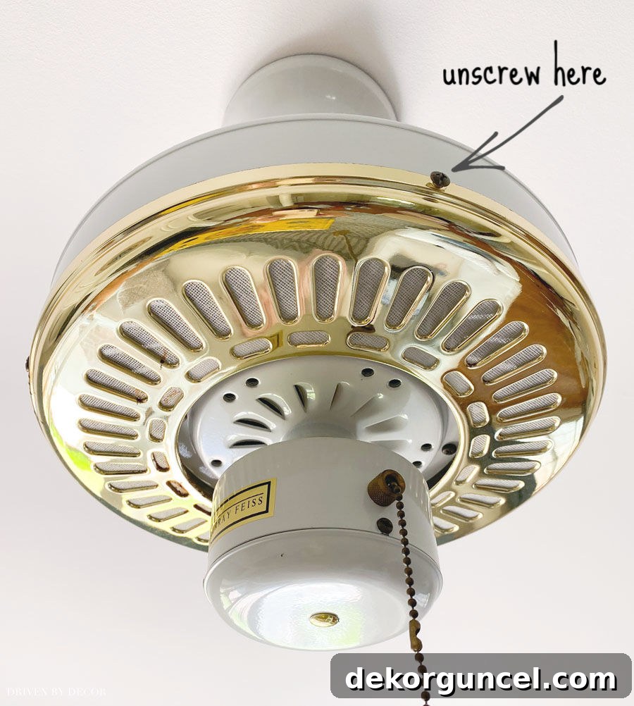 Removing the brass fan pieces for spray painting – a crucial step for a clean finish.