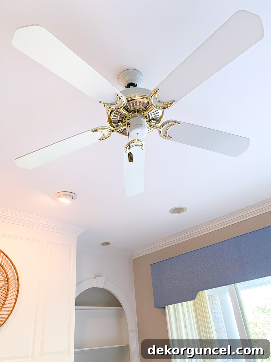 Our brass ceiling fan before painting, highlighting its dated aesthetic.