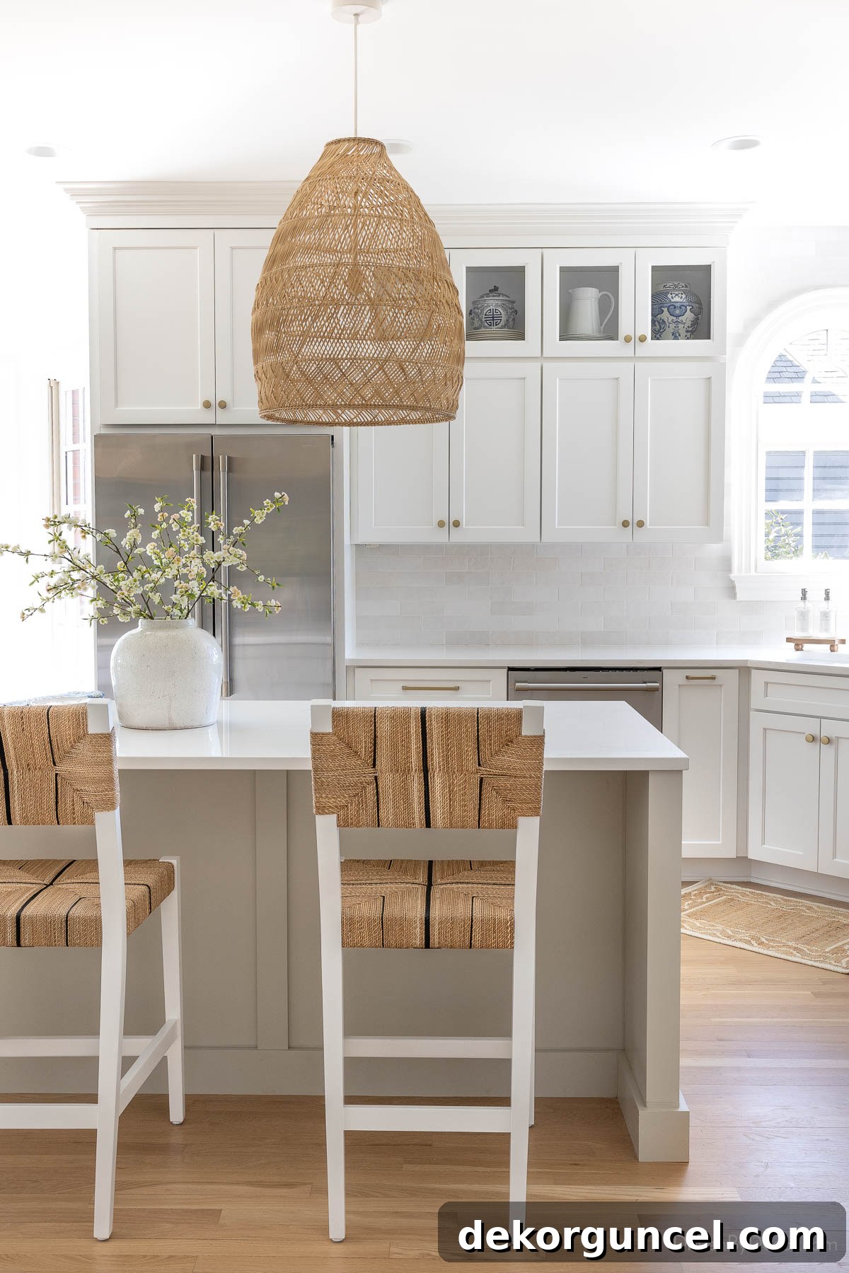 Kitchen with stunning white shaker cabinets along the perimeter, creating a clean and bright aesthetic