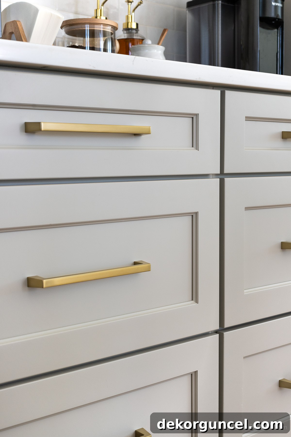 Gray shaker kitchen cabinets on the island, offering a sophisticated contrast to the white perimeter