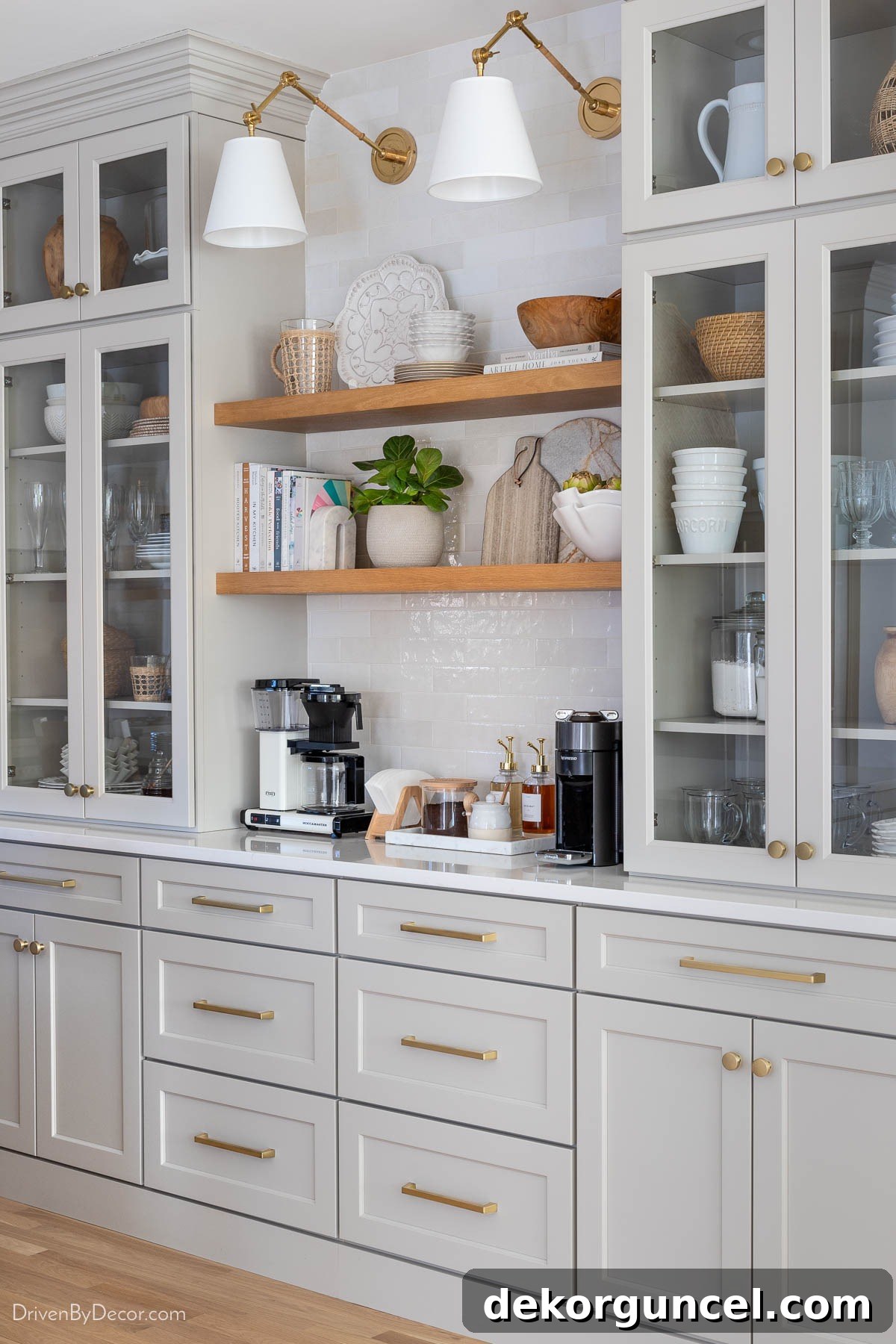 Kitchen coffee bar featuring elegant glass-doored upper cabinets resting on quartz-topped base cabinets, blending style with functionality
