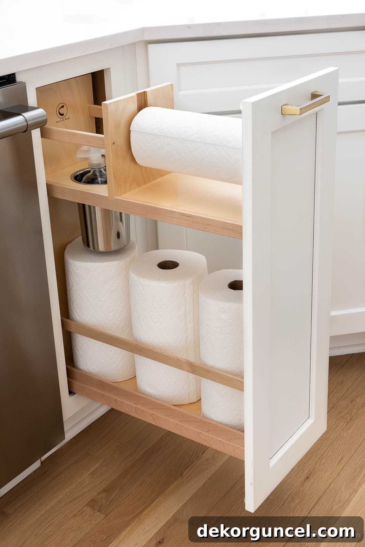 Innovative paper towel pull-out cabinet located near the kitchen sink, designed for convenience and tidiness