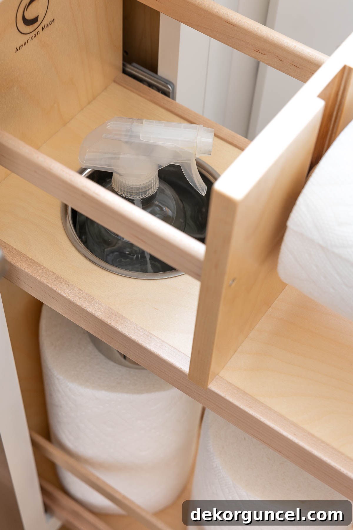 Hidden spray bottle holder within the kitchen paper towel pull-out, maximizing discreet storage
